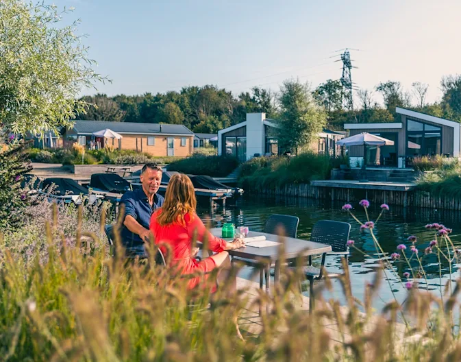 EuroParcs_-_Kraaijenbergse_Plassen_couple_sitting_on_the_terrace_of_their_own_holiday_home